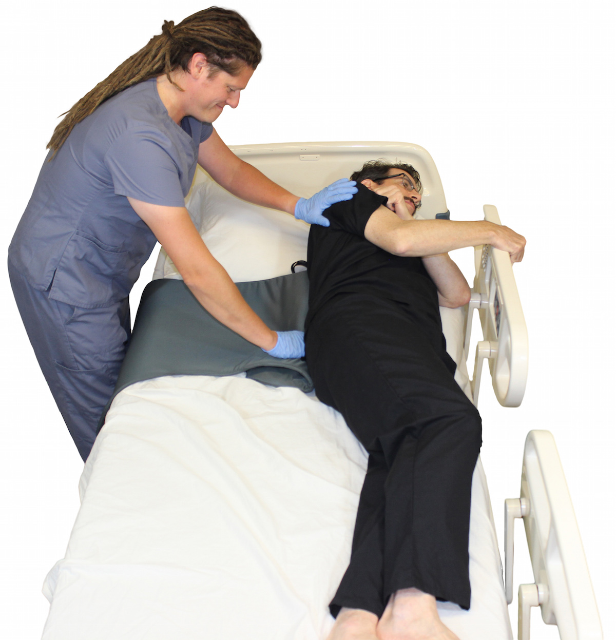 Placing Twin Turner under small of patient's back